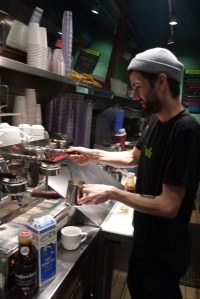 A barista adding Gojiccino to a drink.